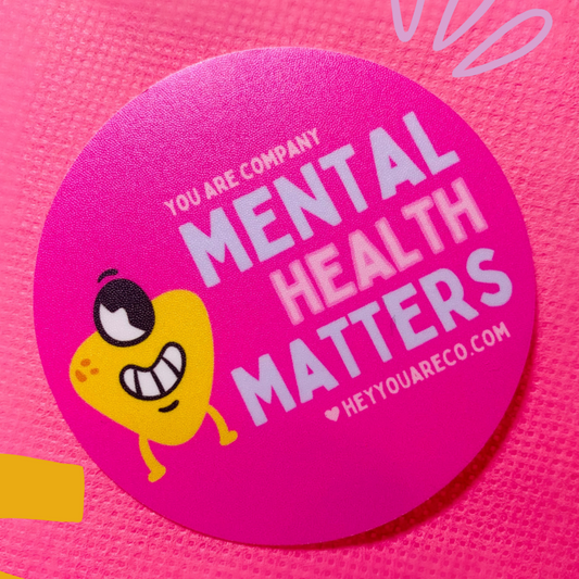 This sticker says "Mental Health Matters"; Colors: Pink, Blue, Yellow; Elements: small blob guy